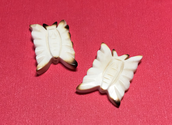 Carved bone bead drilled through butterfly